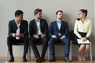 La parité non atteinte en entretien d'embauche 3 hommes et une femme attendant pour un entretien