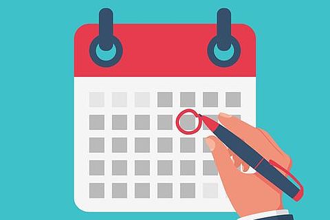 agenda plus large calendrier avec une main qui note un événement